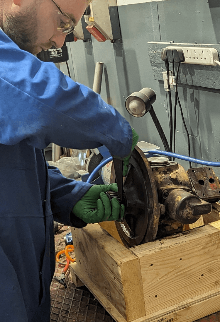 Technician disassembling air motor shaft